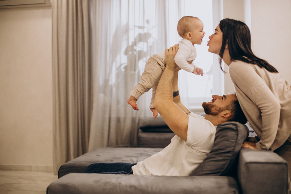 young-family-with-toddler-baby-daughter-sitting-coach-home.jpg